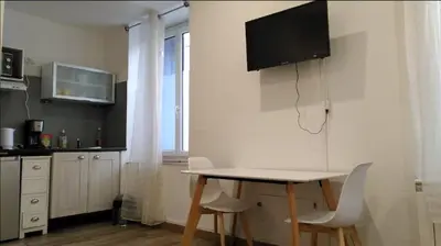 a kitchen with a table and chairs in a room at RDC cosy en centre ville in Narbonne