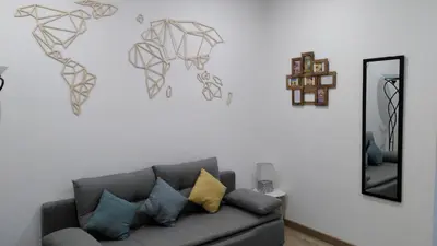 a living room with a couch and a mirror at RDC cosy en centre ville in Narbonne