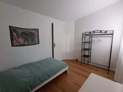 a bedroom with a bed and a ladder in it at LA FALAISE - Quiet T3 apartment with private parking in Caucalières