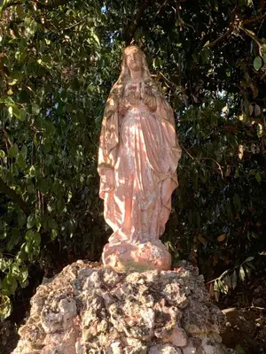 a statue of a woman sitting on top of a rock at Château de Villeneuve - Montolieu in Montolieu