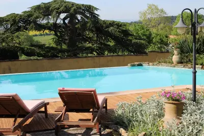 a swimming pool with two lounge chairs next to it at Château de Villeneuve - Montolieu in Montolieu
