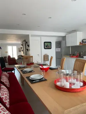 a kitchen and living room with a table with wine glasses at La Novèla, Maison de Village Rooftop in Port-la-Nouvelle