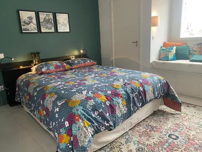 a bedroom with a bed with a colorful quilt at La Novèla, Maison de Village Rooftop in Port-la-Nouvelle