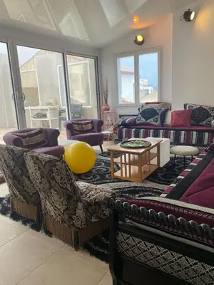 a living room with couches and a table at La Novèla, Maison de Village Rooftop in Port-la-Nouvelle