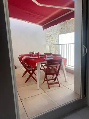 a dining room table with chairs and a red table cloth at La Novèla, Maison de Village Rooftop in Port-la-Nouvelle