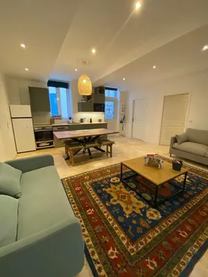 a living room with a couch and a table at Appartement RDC avec cour privée - Narbonne Les Halles Centre Historique in Narbonne