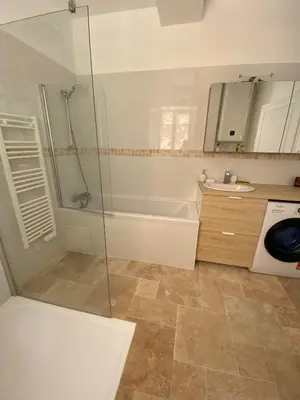 a bathroom with a shower and a tub and a sink at Appartement RDC avec cour privée - Narbonne Les Halles Centre Historique in Narbonne