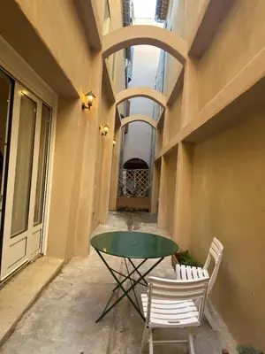 a glass table and two chairs on a patio at Appartement RDC avec cour privée - Narbonne Les Halles Centre Historique in Narbonne