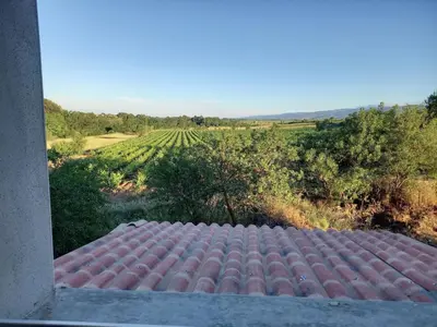 a tiled roof with a view of a field at Domaine Saint Augustin in Rieux-Minervois