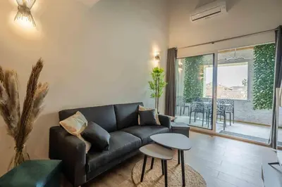 a living room with a couch and a table at L'Hippocrate Duplex à deux pas des Halles in Narbonne