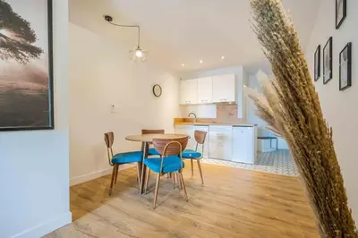 a kitchen and dining room with a table and chairs at L'Hippocrate Duplex à deux pas des Halles in Narbonne