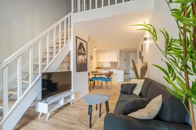 a living room with a couch and a table at L'Hippocrate Duplex à deux pas des Halles in Narbonne