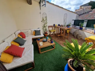 a living room with a couch and a table at Very charming village house in Capendu