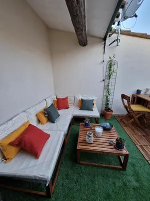 a living room with a couch and a table at Very charming village house in Capendu