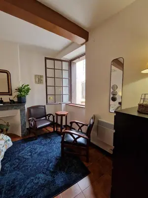 a living room with chairs and a table and a window at Very charming village house in Capendu