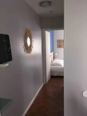 a bedroom with a bed and a mirror on the wall at Plage des Chalets in Gruissan