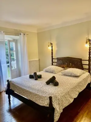 a bedroom with a large bed with two pillows at Bergerie de L'horte in Tourouzelle