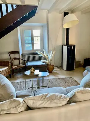 a living room with a couch and a table at Bergerie de L'horte in Tourouzelle