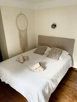 a white bed with two towels on top of it at Bergerie de L'horte in Tourouzelle