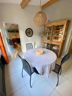 a dining room with a white table and chairs at Bergerie de L'horte in Tourouzelle