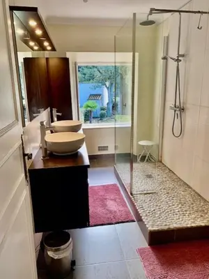 a bathroom with a sink and a glass shower at Bergerie de L'horte in Tourouzelle