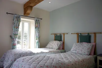 two beds in a room with a window at Domaine de Polf,ages - just for you and your family in Villautou