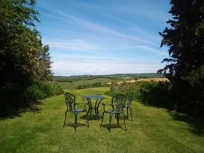 three chairs and a table in the grass at Domaine de Polf,ages - just for you and your family in Villautou
