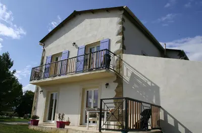 a white house with blue windows and a balcony at Domaine de Polf,ages - just for you and your family in Villautou