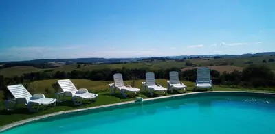 a group of lawn chairs and a swimming pool at Domaine de Polf,ages - just for you and your family in Villautou