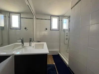a white bathroom with a sink and a shower at Maison 3 pièces - Gruissan GN500-022 in Gruissan
