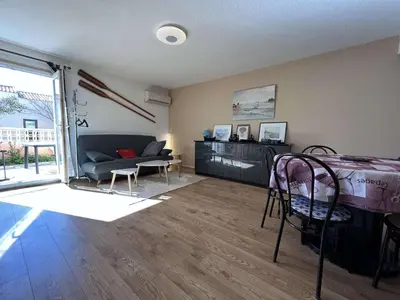 a living room with a couch and a table at Maison 3 pièces - Gruissan GN500-022 in Gruissan