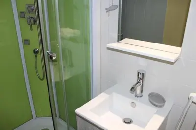 a bathroom with a sink and a shower at Appartement cosy avec vue et piscine sur le port - GN400-013 in Gruissan