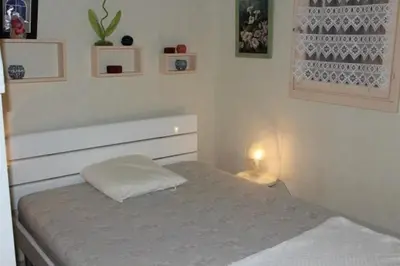 a small bedroom with a bed and a lamp at Appartement cosy avec vue et piscine sur le port - GN400-013 in Gruissan