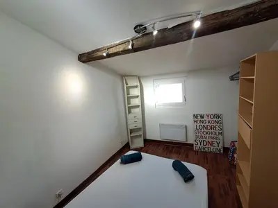 a bedroom with a bed and a ladder in a room at le duplex charmant et cosy in Narbonne