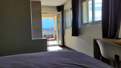 a bathroom with a bed and a tub and a bedroom at DOMAINE LA TOUPIE Chambres d'hôtes in Maury