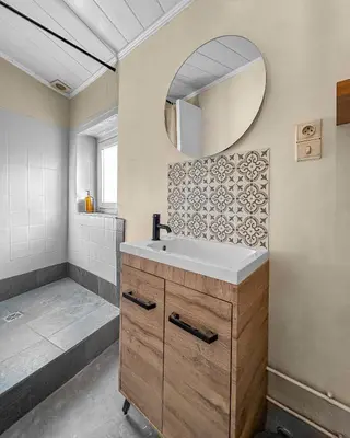 a bathroom with a sink and a mirror at T2 Cosy Vue Sur La Cité in Carcassonne