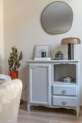 a white console table with a mirror on the wall at Chez Seb - Raffiné et Accueillant in Carcassonne