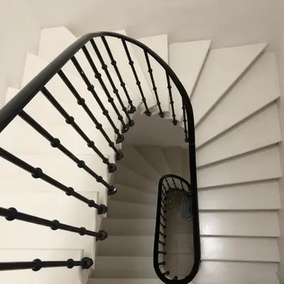 a spiral stairwell with a mirror on it at Stylish large house with heated pool in historic village in Bize-Minervois