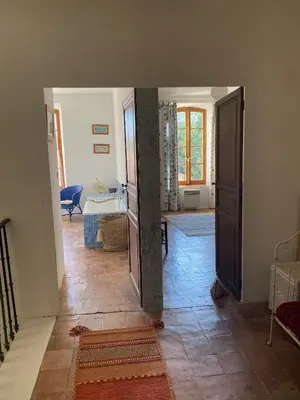 a hallway with a door leading to a living room at Stylish large house with heated pool in historic village in Bize-Minervois