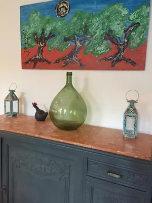 a green vase sitting on top of a cabinet at Stylish large house with heated pool in historic village in Bize-Minervois