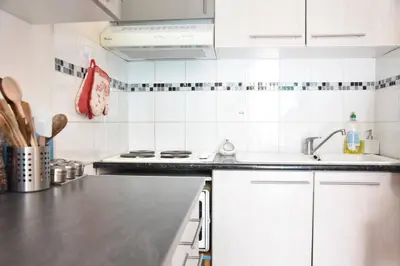 a kitchen with a sink and a counter top at Maison climatisée à 20m du bras de mer GA070-040 in Gruissan