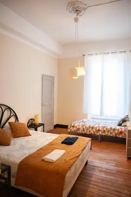 a bedroom with a large bed with two mirrors on the wall at Carcassonne spirit in Carcassonne