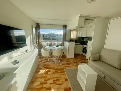a small kitchen with white cabinets and a white refrigerator at Studio rénové, proche port & village, parking, animaux admis - FR-1-796-83 in Gruissan