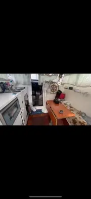 a kitchen with a stove and a table in it at vacances de rêve sur les vagues in Gruissan