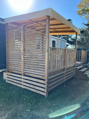 a wooden gazebo with a roof at Mobil-home 3 ch camping TOHAPI in Port-la-Nouvelle