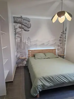 a bedroom with a bed with a painting on the wall at Villa avec piscine privée in Sallèles-dʼAude