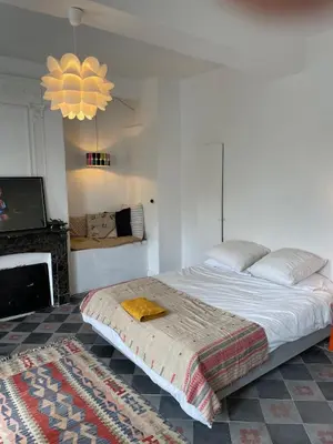 a bedroom with a large bed and a fireplace at Artist Residence - courtyard, terrace, Grand Piano in Siran