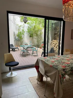 a dining room with a table and a patio at Artist Residence - courtyard, terrace, Grand Piano in Siran