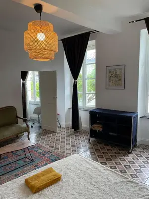 a living room with a bed and a chandelier at Artist Residence - courtyard, terrace, Grand Piano in Siran