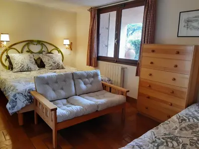 a bedroom with a bed and a couch and a dresser at Alzina in Vingrau
